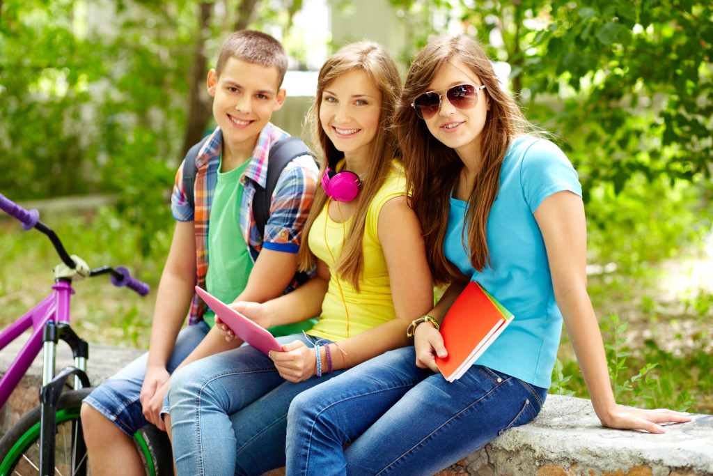 Cheerful teens spending time together after school